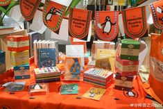 an orange table topped with lots of books