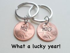 two personalized key chains with the words, what a lucky year