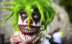 a creepy clown with green hair and makeup