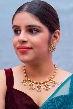 Description: Elevate your look with our Designer Gold Plated Kundan & Ruby Stone Necklace with Earrings. The intricate design and high-quality materials add a touch of elegance to any outfit. Perfect for special occasions or everyday wear, this set is a must-have for any fashion-forward individual. About: Eye-catching and unique jewelry that will set you apart. Gift this piece to a loved one, and see their face light up with joy. Best for gifting or for personal use, wear it to any occasion and Festive Round Jewelry Sets With Matching Earrings, Festive Kundan Necklace With Matching Earrings, Diwali Jewelry Sets With Matching Earrings, Diwali Party Jewelry Sets, Meenakari Jewelry Sets For Parties, Elegant Red Temple Necklace With Meenakari, Ruby Stone Necklace, Silver Pooja Items, Choker Designs