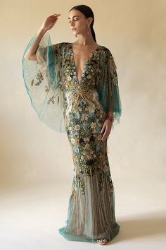 Marchesa mesh v-neck gown in peacock. 92% Silk, 8% Elastic, Lining: 100% Nylon Dry Clean Only Made in USA Marchesa Couture, Emerald Gown, Crystal Gown, Marchesa Fashion, Exclusive Gowns, Peacock Dress, Peacock Pattern, Fashion Gowns, Long Sleeve Gown