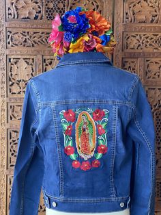 This Lady Of Guadalupe Virgin Embroidered Jeans Jacket is perfect for Fall! This super cool Embroidered Jeans Jacket has a very traditional design embroidered on it. It is made with a very comfortable Jeans material with Spandex. It has pockets and buttons in the front. The jacket is made in Mexico by Artisanal Hands made with love for you. With this jacket you will look gorgeous and fashionable. Winter Multicolor Embroidered Denim Jacket, Fitted Festival Outerwear With Intricate Embroidery, Fitted Multicolor Embroidered Outerwear For Festivals, Fitted Floral Embroidered Outerwear For Festivals, Fitted Denim Jacket With Multicolor Embroidery, Fitted Denim Jacket With Embroidered Patch And Long Sleeves, Fitted Embroidered Denim Jacket For Festival, Old Navy Jean Jacket, Embroidered Jean Jacket