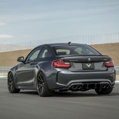 the rear end of a gray bmw car