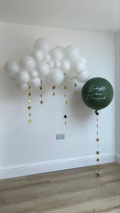 balloons and stars are hanging from the ceiling