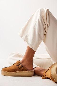 An effortless everyday pair, these mules from Clarks feature premium suede uppers, sat on a slightly wedged platform crepe sole with a buckle and fob detail for added accents. **Features:** Slip-on style, backless design, round toe, suede uppers, center seam, buckle detail, attached fob, slight wedge, platform crepe rubber sole **Why We | Clarks Trek Wedge Mules at Free People in Tan, Size: US 9 Womens Fall Shoes Casual, Temporary Wardrobe, Mules Shoes Outfit, Rich Girl Fashion, Wedge Mules, Sneakers Mode, Backless Design, Clarks Originals, Womens Clarks