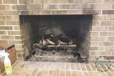 a fire is burning in a fireplace with bricks on the floor and debris around it