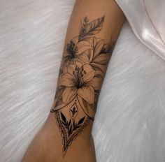 a woman's arm with a flower tattoo on the left side of her body