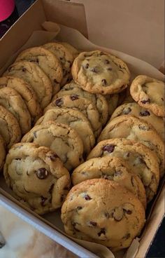 a box full of chocolate chip cookies on a table