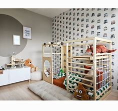 a child's bedroom with a bunk bed and toy animals on the wall behind it