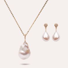 Elevate your allure with the Brilliance Baroque Pearl Set, an epitome of sophistication. Radiate in unique elegance, captivating with the lustrous blend of pearls. Irresistible opulence. Metal: 14K Gold Vermeil Stone Type: Joopita® Stone, PearlChain Length: 40 cm / 15.8" with extensions from 40 cm to 45 cm (15.8" - 17.71") Dimensions: Charm: 15 mm / 0.59" x 20 mm / 0.79" Earring: 9.1 mm / 0.36" x 23.2 mm / 0.91" Dimensions: 8 mm / 0.31" x 9 mm / 0.35" Total Weight: 10.5g Elegant Gold Briolette Pearl Necklace, Elegant High Luster Pearl Necklace For Anniversary, Luxury Baroque Pearl Drop Jewelry, Luxury Baroque Pearl Necklace For Wedding, Luxury Baroque Pearl Necklace, Luxury Pear-shaped Pearl Drop Necklace, Yellow Gold High Luster Pearl Necklace For Wedding, Elegant Formal Pearl Necklace With High Luster, Luxury Baroque Pearl Jewelry For Wedding