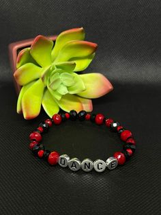 Black & Red Dance Stretchy Bracelet About the product  Colors: Black & red  Materials: Glass & Acrylic  * This one of a kind bracelet would be perfect to bring a smile to your friends and family. It is lightweight and fashionable, as well as stretchy. It's the perfect gift for family members or friends that love dance! * Contact and Follow Us!  If you have any questions about this bracelet feel free to message us on Etsy. We will be happy to answer them.  Shop our store:  https://www.etsy.com/shop/Toparadiseandbeyond Facebook: https://m.facebook.com/To-Paradise-And-Beyond-194702878032699/ Instagram: https://www.instagram.com/toparadiseandbeyondco/ Red Adjustable Stretch Bracelet, Personalized, Red Adjustable Personalized Stretch Bracelet, Adjustable Personalized Red Stretch Bracelet, Red Stretch Bracelet For Friendship In Trendy Style, Red Trendy Stretch Bracelet With Letter Beads, Trendy Red Stretch Bracelet With Letter Beads, Trendy Red Stretch Bracelet For Friendship, Black Bracelets For Party On Valentine's Day, Adjustable Red Bracelet With Letter Beads