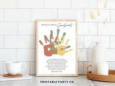 a printable handprint with the words world's best grandparents on it next to a coffee cup and vase