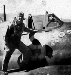 a black and white photo of a man standing next to an airplane