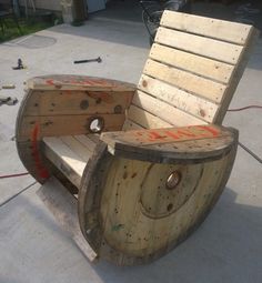 a wooden chair made out of wood with wheels attached to it