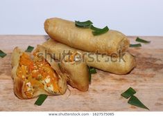 some food is laying on top of a wooden cutting board and ready to be eaten