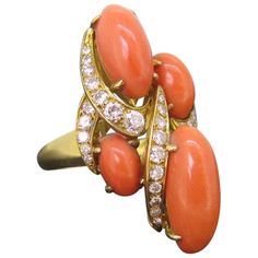 A beautiful coral and diamonds ring. This one was perfectly handcrafted in 18kt yellow gold and adorned with 4 beads of polished corals. These are in very good vintage condition. They have a beautiful reddish orange color. The largest bead is 17,78 mm long and the smallest one is 8,95 mm. The ring is set with 25 brilliant cut diamonds for a total carat weight of 2ct approximately. It is easily resizable, feel free to ask we will be happy to do it for you (included into the price) All our items come with either a gemological report or a jewelry report with circa and all useful information. Weight : 13,7 gr Dimensions : • Length: 36,45mm / 1,43 in • Height: 22,27mm / 0,87in • Width / Face: 33,02mm / 1,3in Ring size : 9 / 60 / R 3-4 Stones : Natural Coral and diamonds Metal : 18kt yellow gold Coral Jewelry Vintage, Cocktail Fashion, Gorgeous Rings, Reddish Orange, Diamonds Ring, Coral Jewelry, Fashion Ring, Coraline, Dream Jewelry