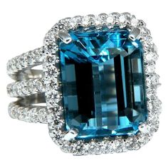 15.00ct. Natural Emerald cut Swiss Blue Topaz Ring Topaz: 14 x 11.5mm Emerald Full cut brilliant Transparent and Clean Clarity 2.40ct. Side natural round white diamonds: G- Color, Vs-2 clarity. 14kt. White gold 13.5 grams Ring Current size: 6 Depth of ring: 8.8mm $7000 Appraisal Will accompany. Luxury Topaz Ring Emerald Cut With Vvs Clarity, Luxury Emerald-cut Topaz Ring With Vvs Clarity, Luxury Gia-certified Emerald Cut Topaz Ring, Luxury White Gold Octagon Topaz Ring, Luxury Octagon Brilliant Cut Topaz Ring, Grad Rings, Stunning Aesthetic, Swiss Blue Topaz Ring, Blue Diamond Ring