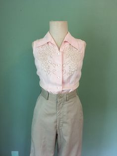 "1940s handmade blouse pink, lightweight cotton sleeveless Mother Of Pearl buttons lace front detail waist darts up front bust darts from side slanted up beautiful long collar pointed down good vintage condition w/wear- patched and mended by me(see last 3 pictures) measures, lying flat, shoulder-13\" chest-17\" waist-14\" hem-18\" length-23\"     We do not offer returns or refunds unless something is grossly misrepresented. Please contact us within 2 business days of receiving to discuss any possible returns for this reason. We do not offer refunds for your shipping fees. Please feel free to contact us with any questions you may have about an item prior to purchase and we will gladly answer them." Feminine Fitted Collared Top, Fitted Sleeveless Blouse With Button Closure, Vintage Spring Tops With Lace Trim, Vintage Fashion Lace Trim Tops For Spring, Vintage Lace Trim Tops For Spring, Spring Vintage Fashion Tops With Lace Trim, Spring Vintage Lace Trim Tops, Fitted Button-up Blouse With Lace Collar, Fitted Button-up Blouse With Lace Trim