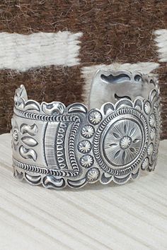 This sterling silver bracelet was made by Navajo silversmith Eugene Charley. The inside is signed and stamped sterling.Size: 5 3/4" (will fit up to a 7" wrist)Gap: 1 1/4"Width: 1 1/2"Free shipping on all orders! We ship with USPS and always include tracking. All orders ship within a day of payment.Returns are accepted up to 30 days after you receive your order. Just send us a message. Our shop offers cash back or store credit. The item must be returned in new condition. Western Sterling Silver Cuff Bracelet Gift, Western Style Silver Cuff Bracelet Gift, Western Style Silver Cuff Bracelet As A Gift, Handmade Western Sterling Silver Cuff Bracelet, Sterling Silver Etched Cuff Bracelet, Handmade Western Silver Cuff Bracelet, Western Style Stamped Cuff Bracelet, Artisan Sterling Silver Concho Cuff Bracelet, Vintage Sterling Silver Concho Cuff Bracelet