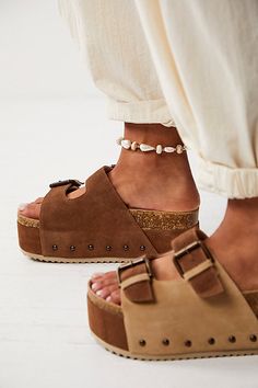 Turn heads in these so bold and statement-making sandals featured in a slip-on style and two-strap design with a chunky flatform sole, studded embellishments, and buckle detailing. * Open-toe design * Molded cork footbed * Wood hand carved base | Rule Breaker Flatform Sandals by Intentionally Blank at Free People in Brown, Size: EU 39 Making Sandals, Beach Flats, Birkenstock Madrid Big Buckle, Moon Earth, Intentionally Blank, Suede Clogs, Rule Breaker, Cork Sandals, Sandals Outfit