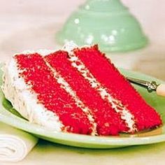 a slice of red velvet cake on a green plate