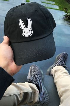 Embroidered BAD BUNNY Dad Hat Trendy Short Brim Hat, Trendy Adjustable Visor Snapback Hat, Trendy Adjustable Snapback Baseball Cap, Trendy Adjustable Fit Cap, Trendy Adjustable Cap, Trendy Everyday Cap Hat, Trendy Everyday Cap, Adjustable Dad Hat With Short Brim For Streetwear, Trendy Black Dad Hat For Outdoor