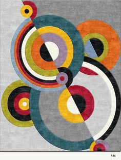 an abstract rug with various colored circles and shapes on grey ground, in front of a white background