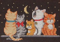 cross - stitch pattern of four cats sitting on a window sill with the moon and stars in the background