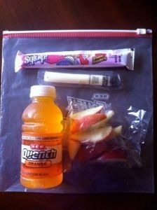 an assortment of fruit and candy in a plastic bag