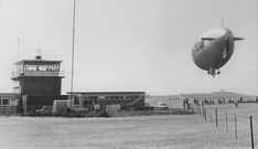 an airplane is flying over the airport with people