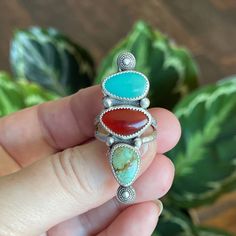 This triple stone ring has lots of fun colors going on with both green and blue turquoise and a deep orange carnelian.  She is a vibrant statement piece with a rustic vibe.  I gave her sterling silver bead accents and a textures sterling split shank band. Measurements:  47mm x 16mm Ring Size:  8.5 Turquoise is known as the master healing stone.  Attributed to the power of connecting mind, body, and soul, it is also a symbol of superior energies and spiritual openness. Known as an artist's stone, the Carnelian crystal is a warm, vibrant stone that boosts confidence and the power of true expression.  This stone empowers your self-confidence in all aspects of your life - from relationships and professional pursuits to personal projects. When you are searching for a stone to help you tap into Unique Three-stone Ring Jewelry, Unique Multicolor Oval Gemstones, Turquoise Three Stone Ring For Gift, Turquoise Three Stone Ring As A Gift, Adjustable Multicolor Multi-stone Turquoise Ring, Multicolor Oval Fusion Rings, Turquoise Multi-stone Ring For Gift, Unique Multicolor Multi-stone Rings, Oval Multicolor Turquoise Ring With Natural Stones