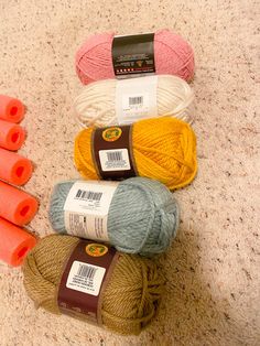 several balls of yarn are sitting on the floor