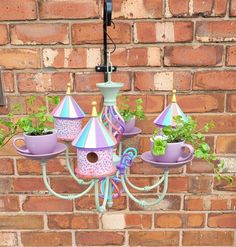 a purple chandelier hanging from a brick wall