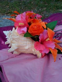 an arrangement of flowers on a pink cloth