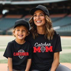 Custom Catcher Mom Tee.  You can personalize with your choice of colors and includes a name/number on the back.   Coordinating Kids Tee here: https://ourwildflowers.etsy.com/listing/1571735831 * Optional: Swap for glitter!  Please visit this link to see glitter options and add to your cart: https://www.etsy.com/listing/994799246/additional-order-add-ons?ga_search_query=add%2Bons&ref=shop_items_search_1&frs=1 D E T A I L S *  Tee is 100% Cotton by Bella + Canvas * The tees are unisex, please refe Black Customizable Team Spirit Tops, Customizable Black Team Tops, Customizable Black Fan Apparel Tops, Black Tops With Name Print For Baseball Season, Customizable Cotton Sports T-shirt, Family Matching Sports Event Tops With Team Name, Family Matching Short Sleeve Tops For Sports Events, Customizable Sporty Short Sleeve Tops, Family Matching Fan Merchandise Tops With Team Name