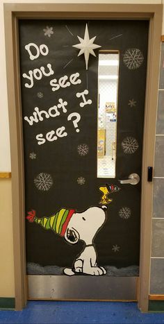 a door decorated with the words do you see what i see? and a cartoon dog holding a party hat