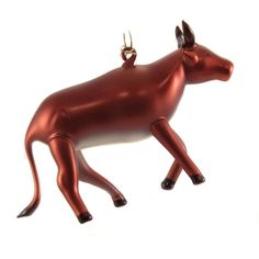 a shiny red cow ornament on a white background