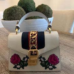 Gucci Mini Sylvia Bag With Embroidery Featuring Top Handle And Rope Strap . Brand New Condition . Comes With Dust Bag . White Gucci Shoulder Bag With Detachable Handle, Gucci White Shoulder Bag With Detachable Handle, Chic Top Handle Bags With Embroidered Logo, White Gucci Bag With Detachable Handle, Designer Rectangular Bag With Embroidered Logo, Gucci Rectangular Bag With Embroidered Logo, Gucci Designer Bag With Embroidered Logo, Designer Gucci Bag With Embroidered Logo, Luxury Shoulder Bag With Embroidered Logo And Top Handle