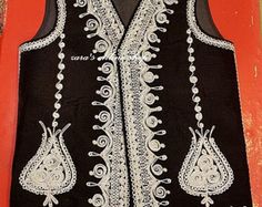 "Here is an Afghan Kuchi Pashtun men handmade zari gold and silver embroidery work vest waistcoat. Traditionally such vests are used on special events like wedding Nikah and Mehndi event. Available in small, medium and large size. It contains very beautiful golden color threads embroidery work which is traditionally called \"Zari or Tilai\" embroidery work. Fabric is long lasting, comfortable and breathable." Traditional Nehru Jacket With Intricate Embroidery, Traditional Sleeveless Nehru Jacket With Intricate Embroidery, Elegant Embroidered Festive Vest, Traditional Sleeveless Vest With Resham Embroidery, Traditional Festive Vest With Intricate Embroidery, Traditional Black Nehru Jacket With Mirror Work, Traditional Fitted Vest With Intricate Embroidery, Fitted Traditional Vest With Intricate Embroidery, Traditional Sleeveless Vest For Eid