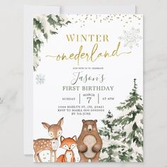 a winter onederland first birthday party with deer and snowflakes on it