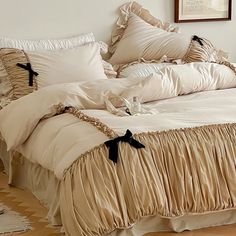 a bed with white sheets and black bows on it