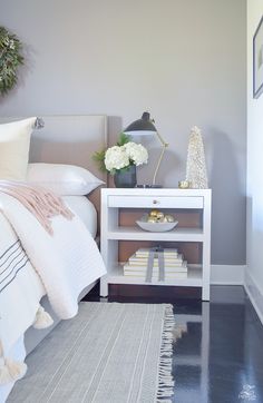 a white bed sitting next to a night stand