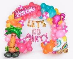 balloon arch that says let's go party surrounded by balloons and palm tree decorations