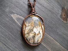 A fantastic plume agate stone intricately hand wrapped in antiqued copper.  The pendant measures 2.75" x 1.5" Pendant hangs from your choice of copper chain or faux black leather cord.  Handmade jewelry by Sigrid Anne Design. Plume Agate, Agate Pendant Necklace, Copper Chain, Agate Pendant, Agate Stone, Antique Copper, Copper Wire, Leather Cord, Handcrafted Jewelry