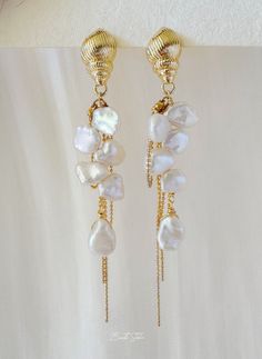 These earrings feature genuine freshwater baroque pearls delicately connected with small, varied shapes of Keshi pearls, creating an enchanting asymmetrical design and graceful lines.  P E A R L ∙ E A R R I N G S ✨Total Length : about 8.5 cm ✨Color: natural untreated, metallic white with tint of blue overtone ✨Material: Ear studs are gold plated S925 sterling silver, suitable for sensitive skin.  It is nickel free, hypoallergenic, tarnish resistant O T H E R ∙ I N F O R M A T I O N ✨ Our pieces are made with care and attention to details. ✨Freshwater pearls are entirely natural, which means that each one has its own distinct size and shape. I'll take care to ensure that the pearls harmonize beautifully with each other. ✨ The orders typically take 1-3 days to process.  ✨ Your satisfaction i Blue And Pearl Earrings, Baroque Pearl Drop Dangle Earrings, Delicate Baroque Pearl Earrings For Pierced Ears, Dangle Earrings With Baroque Pearl Chain, Baroque Pearl Dangle Earrings With Pendant, Baroque Pearl Earrings With Pearl Charm For Jewelry Making, Baroque Pearl Pendant Dangle Earrings, Dainty Baroque Pearl Dangle Earrings, Baroque Pearl Dangle Earrings For Gift