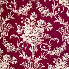 a red and white wallpaper with floral designs on the side, in an ornate pattern