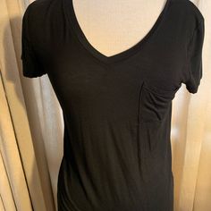 Super Comfortable V Neck Shirt!! New Without Tags. Medium Trendy Black Top With Relaxed Fit, Black Cotton V-neck Shirt, Trendy Black Tops With Relaxed Fit, Trendy Black Relaxed Fit Tops, Black T-shirt With Shirttail Hem For Spring, Black Summer T-shirt With Shirttail Hem, Black T-shirt With Shirttail Hem For Summer, Black V-neck T-shirt For Everyday, Black Shirttail Hem T-shirt For Summer