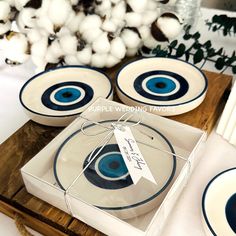 the table is set with blue and white plates, napkins, and place cards