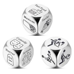 three metal dices with different types of stickers on the top one is white