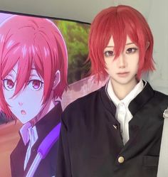 an anime character with red hair standing in front of a television screen and wearing a black jacket